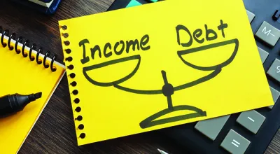A drawing on a ripped out piece of paper from a notebook of an evened scale with debt on one side and ratio on another